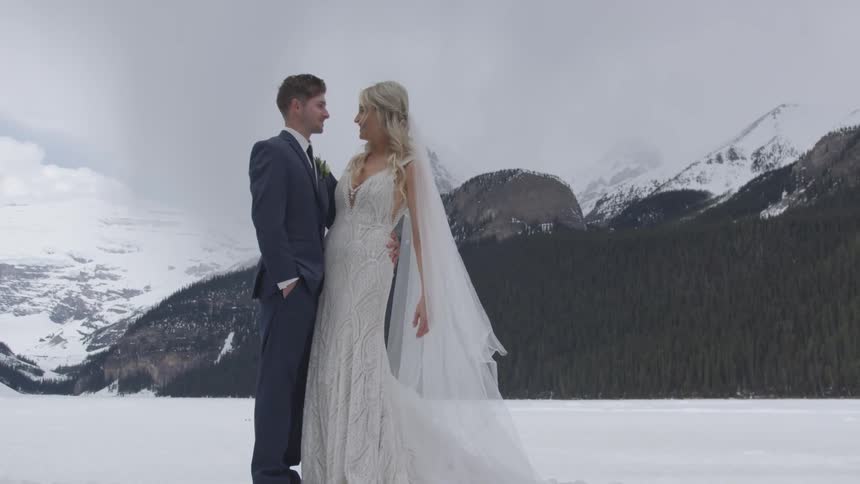 Bride and groom posing outdoors on the snow in the mountains