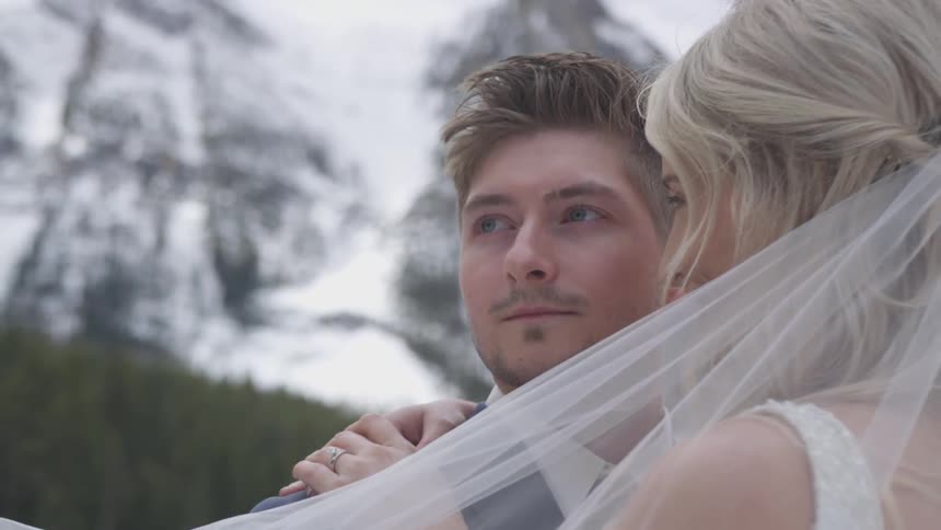 A bride and groom embracing outdoors