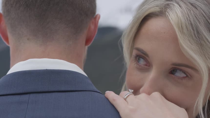 Groom and bride cuddle each other during the wedding ceremony
