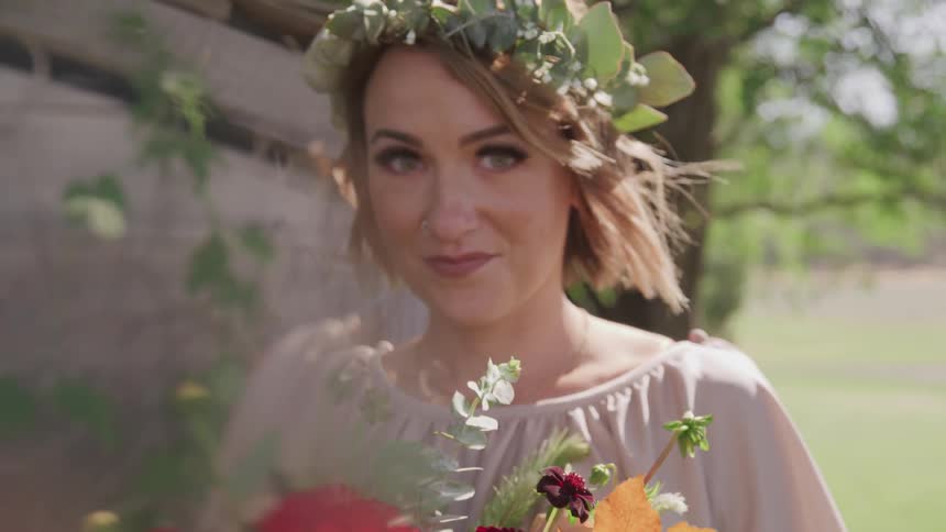 A portrait of groom with flower bouquet