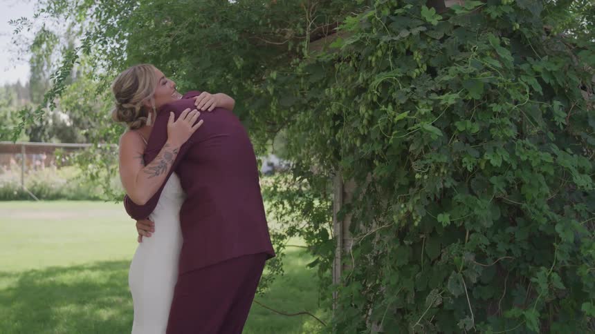 Groom and bride cuddle each other during the wedding ceremony