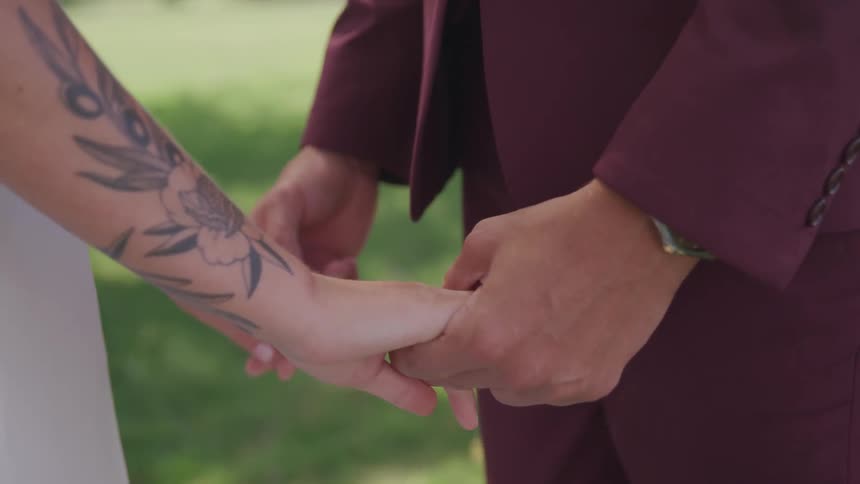 A man and woman hold hands