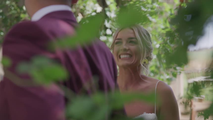 A bride smiles at her groom