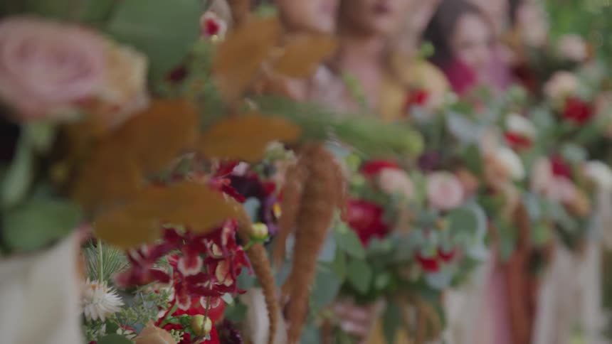 A group of bridesmaids stand together holding bouquets