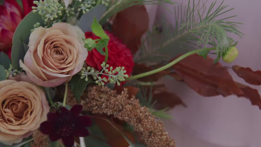 A bouquet of flowers and plants move in the wind