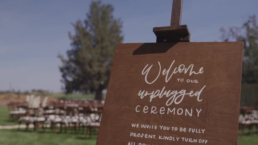 A sign welcomes guests to a wedding ceremony