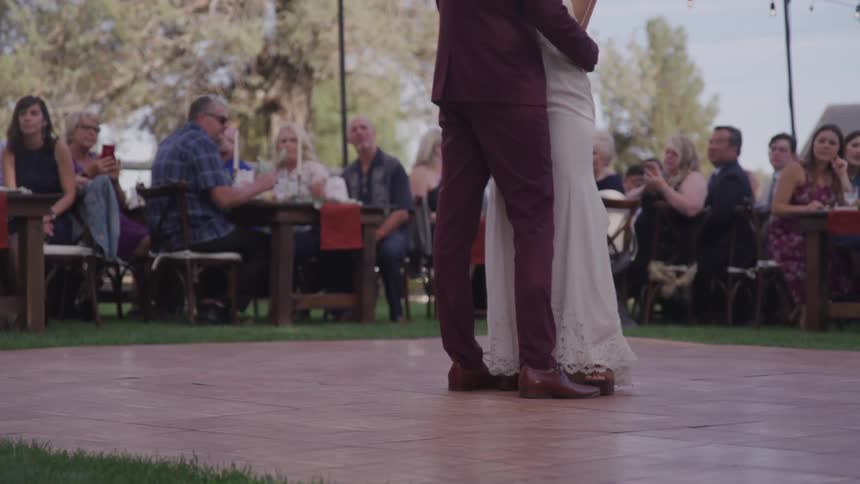 Bride and grooms first dance as guest watch at reception