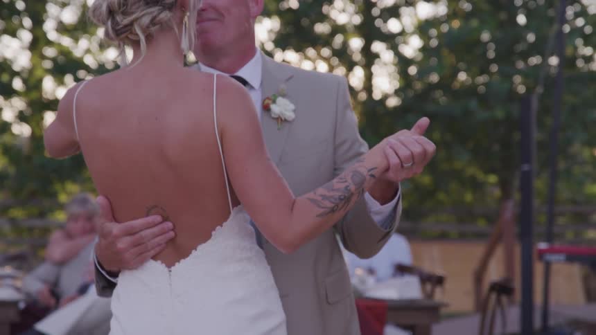 Bride dances with her father at an outside wedding reception