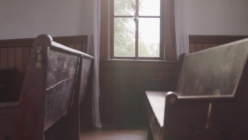 Rows of pews in a building during the day