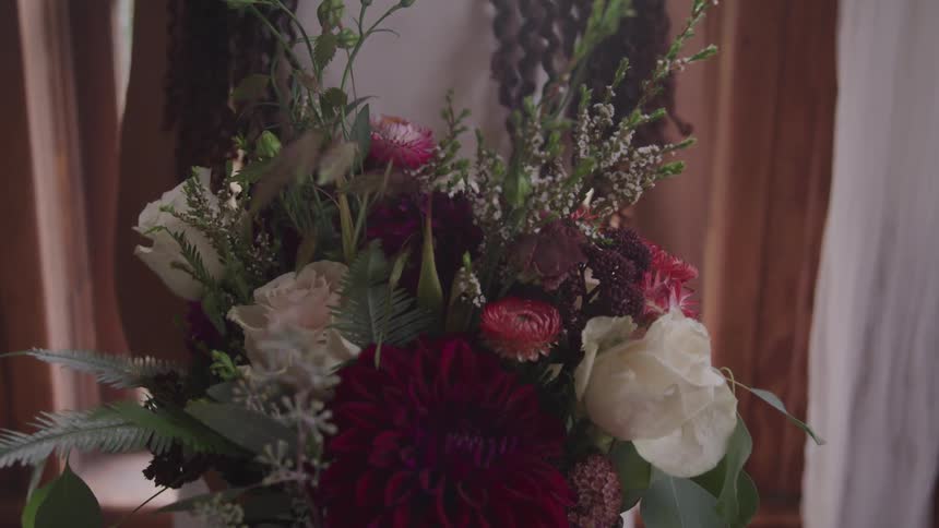 The flower arrangement is set by the door