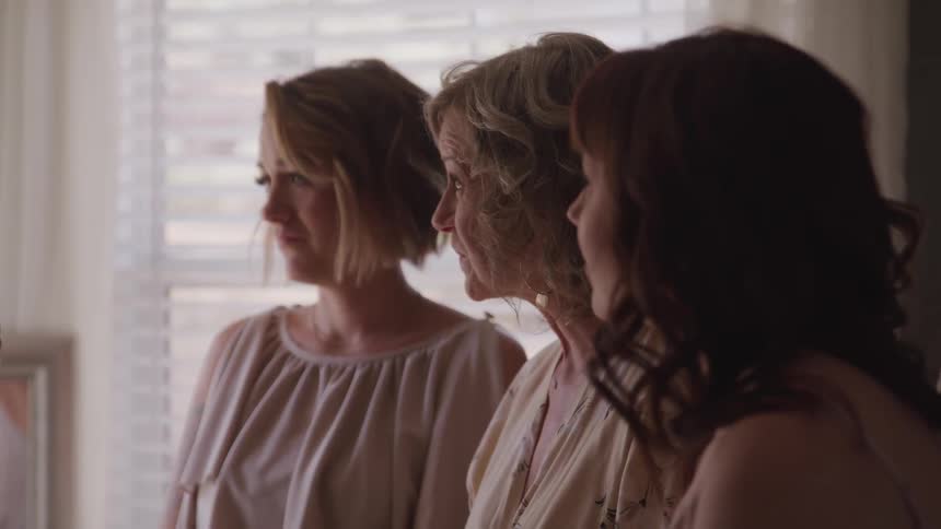 Three people are standing in a room together