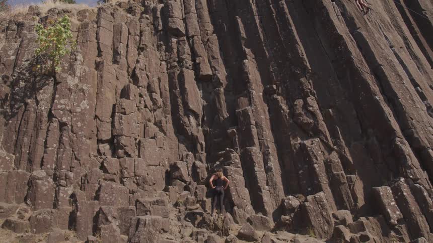 Woman getting read to climb a rock wall