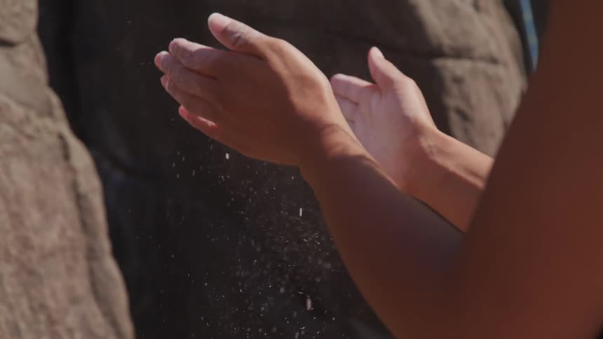 A person rubbing their hands together