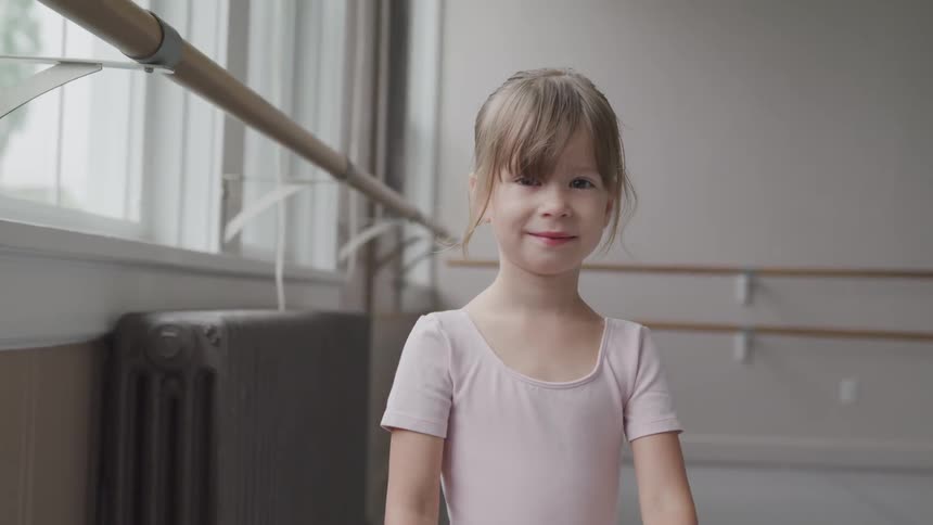 A little girl smiling toward the camera