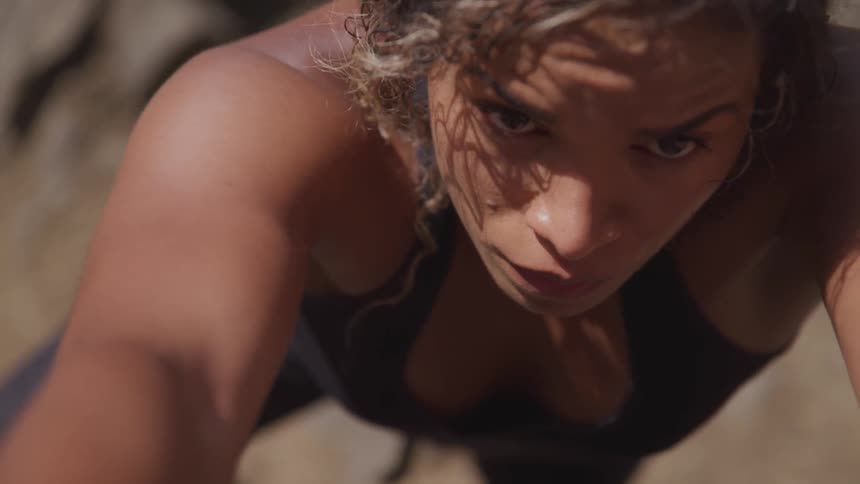 A beautiful black woman doing rock climbing