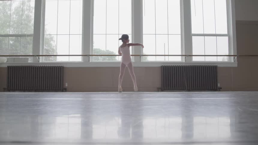A girl doing ballet at the room