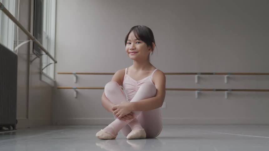 Little girl with ballet suit smiling