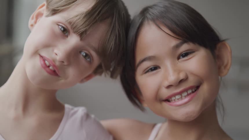 2 girls smiling at the camera