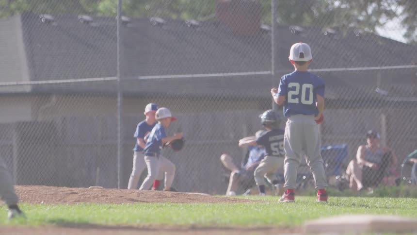 Children play a game of baseball together