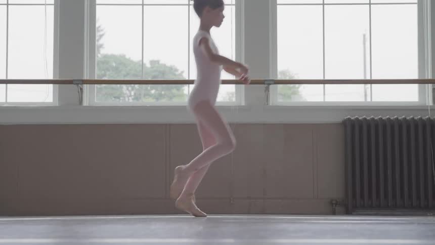 A little girls dances across the floor