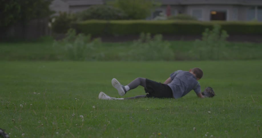 A boy is running across and catches the ball