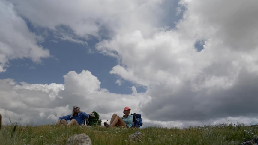 Two people sitting on a field