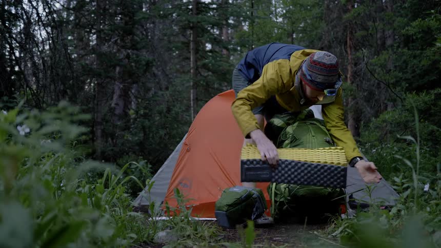 Man packing up camping gear