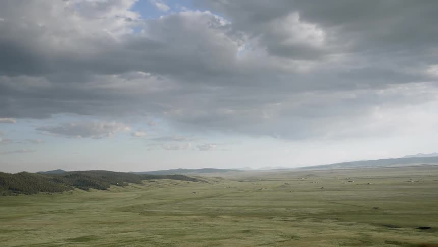 A massive expanse of grasslands are seen sprawling off into the horizon