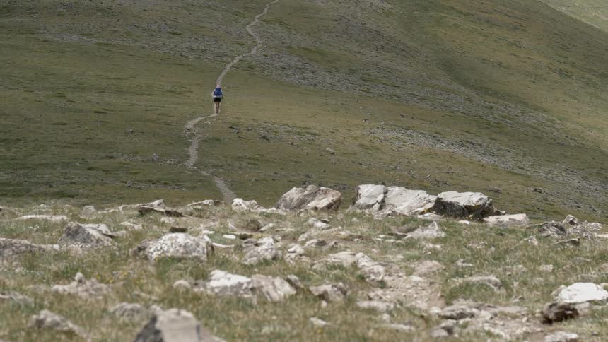 A man walking in the mountain path