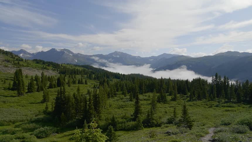 An aerial view of a hill and mountain range