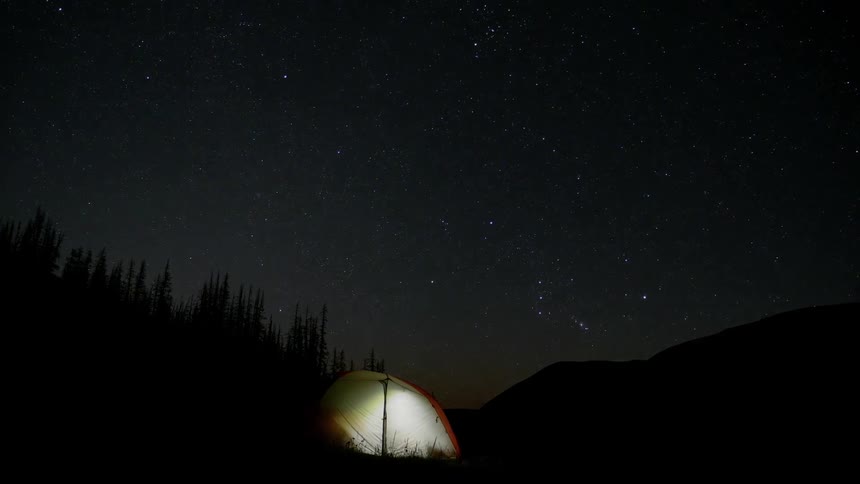A light shining from a tent at night