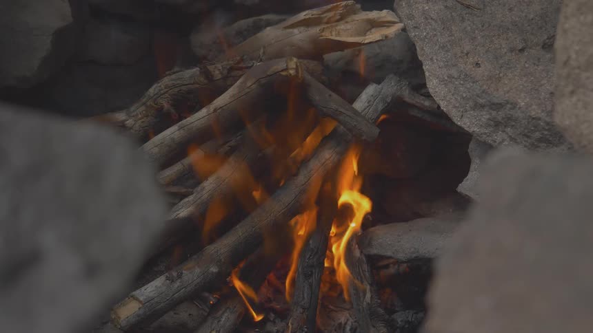 Wood fire burns in stone crevice
