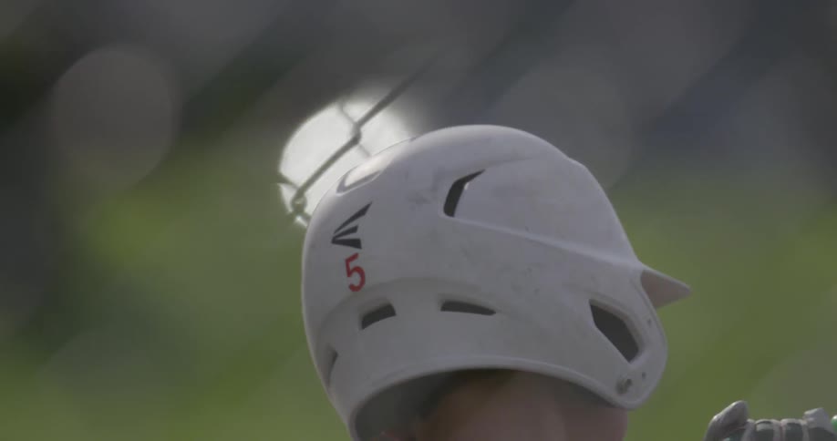 Close up of a boy swinging a bat