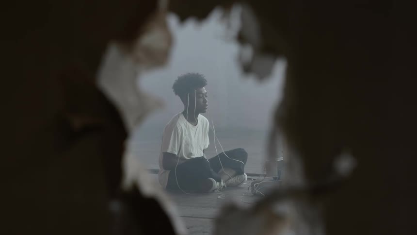A portrait of a boy sit in a room