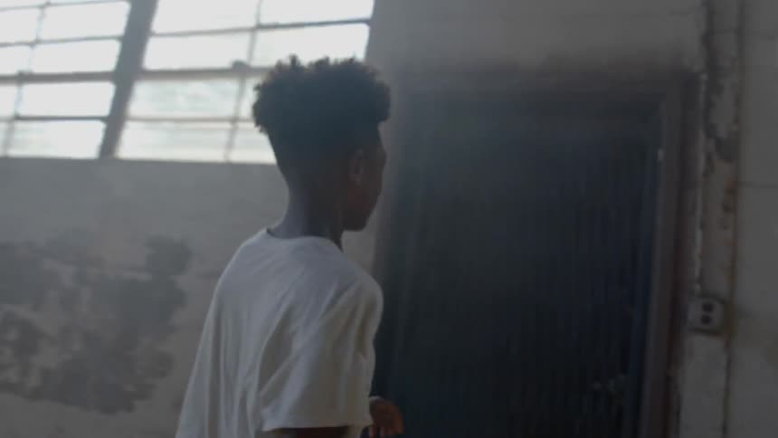A black teen running from a warehouse