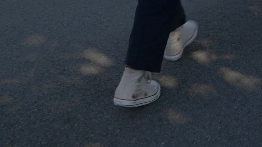 A person walking on asphalt
