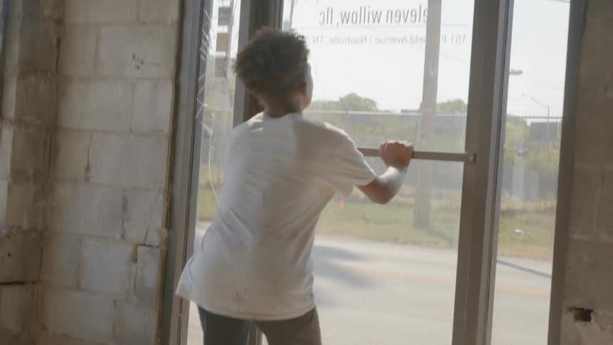A boy running to a door that is locked and turns the other direction