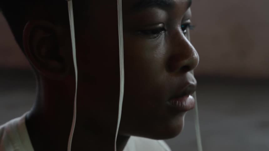A person sits with electrodes hooked to their head