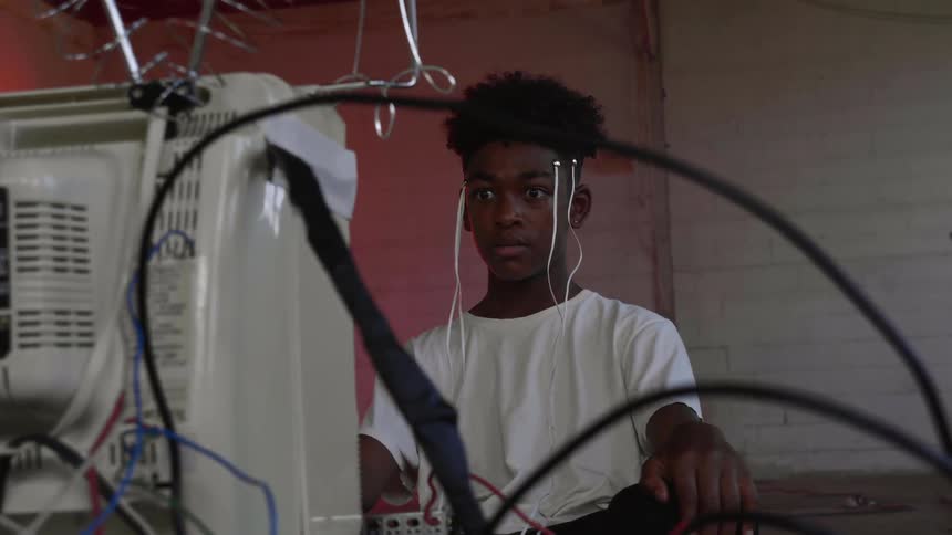 A teenager with electrodes connected to his head