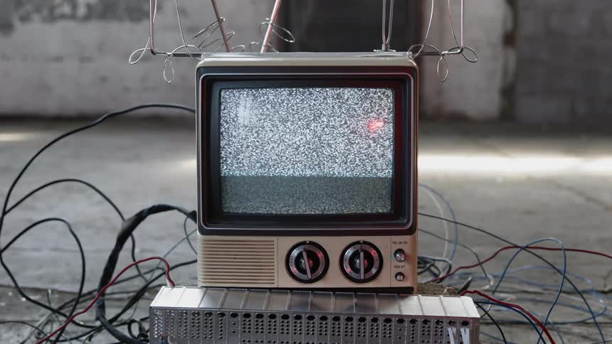 Small vintage television showing static on the screen