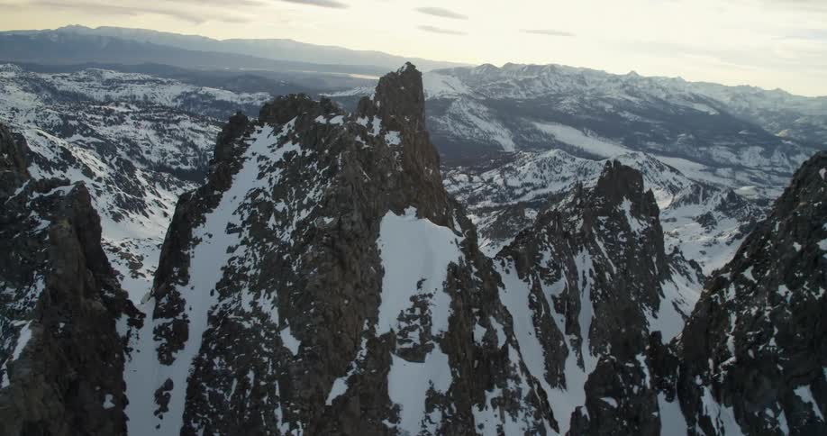 Snow covered mountain peaks at sunset
