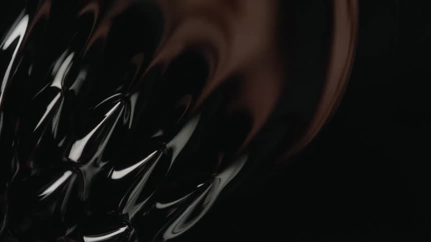A hand reflects in abstract liquid