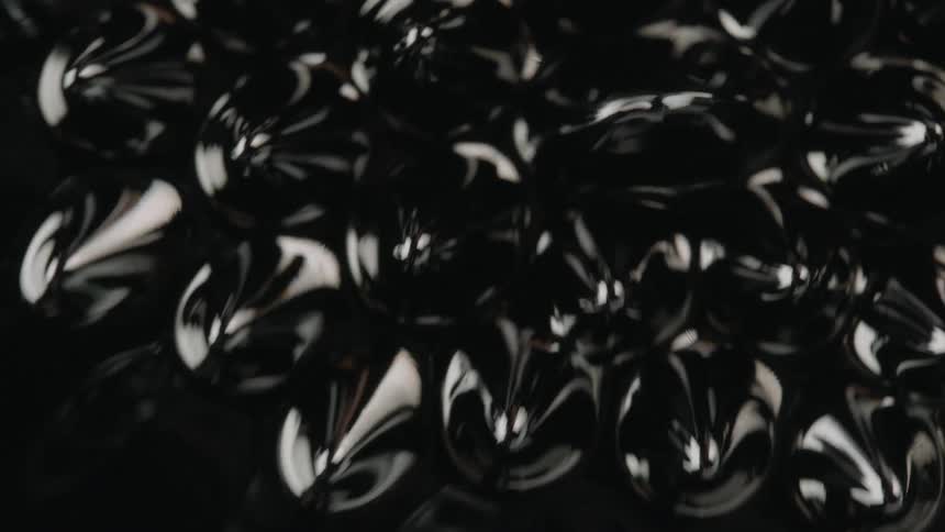 Light reflection and vibration create peaks and patterns on black