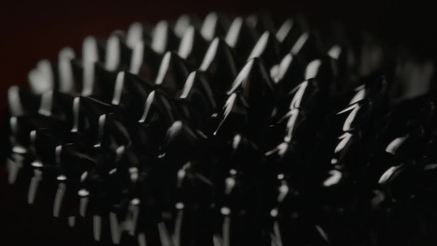 Black pointed objects expand outwards from a circle