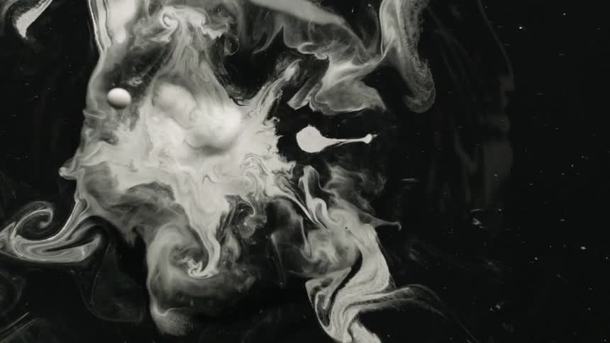 White paint falls into black paint