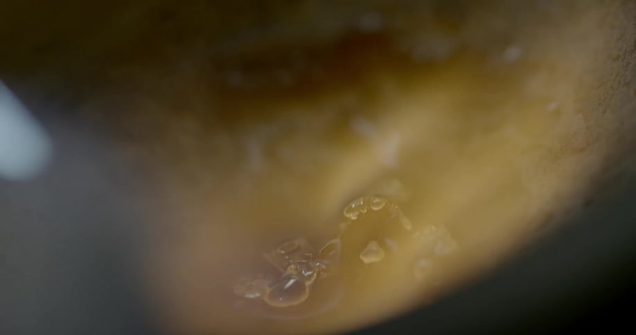 Steam rise over bubbling torched liquid metal