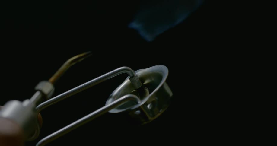 A person lights a blowtorch
