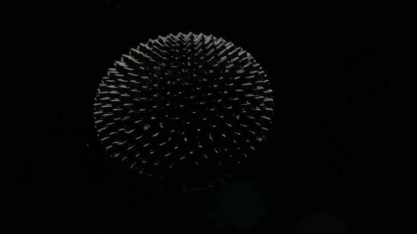 A ferrofluid moves in a dark space