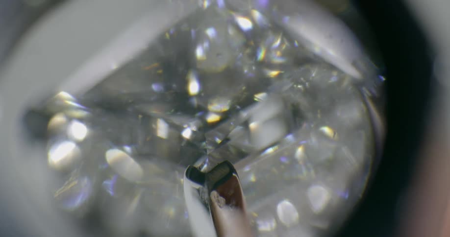 Diamond ring being inspected under a loupe