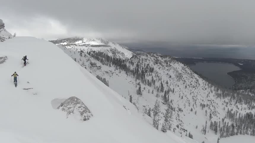 2 men hiking a snowy mountain